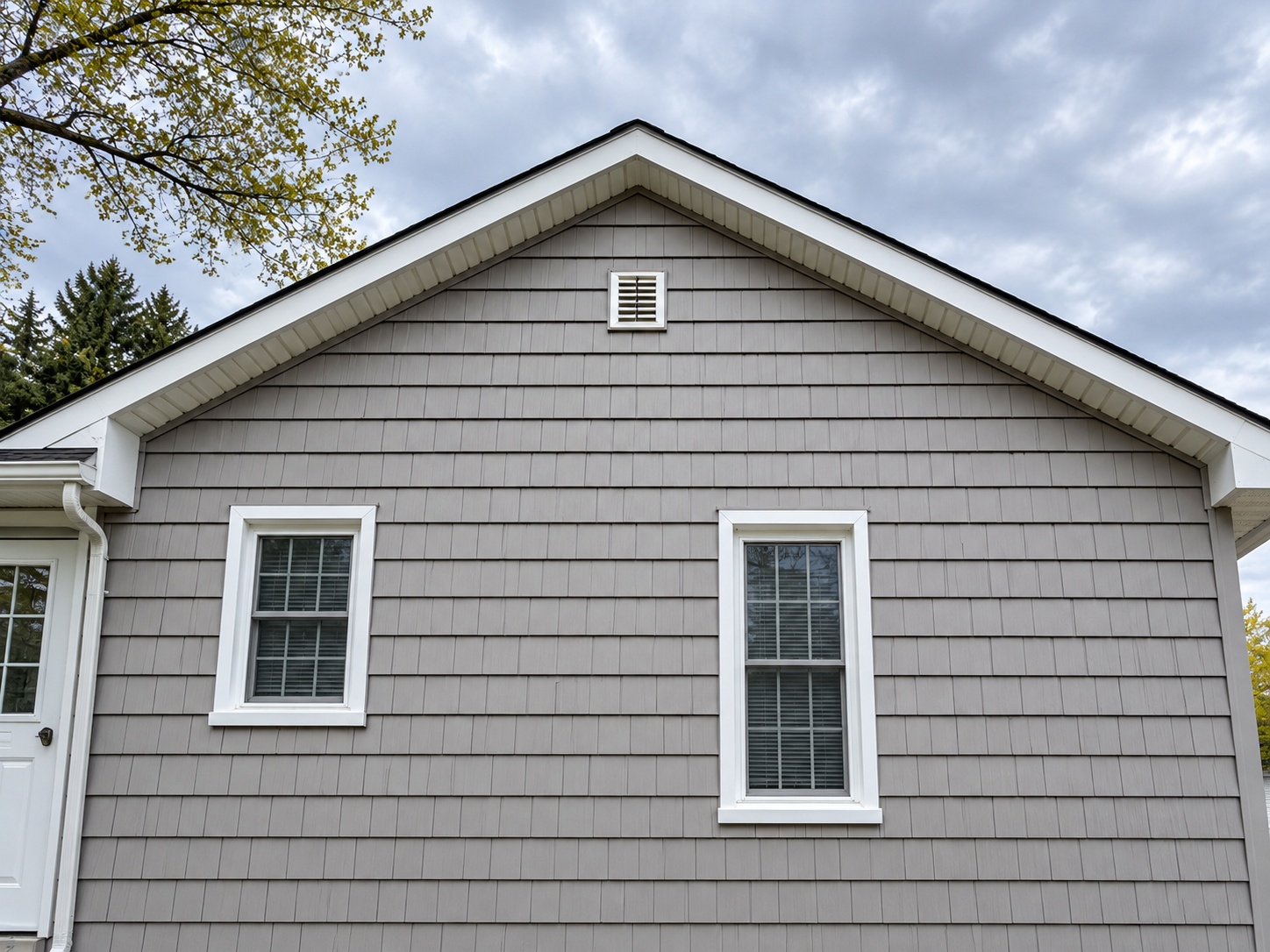 Repaired gable, new siding and trim