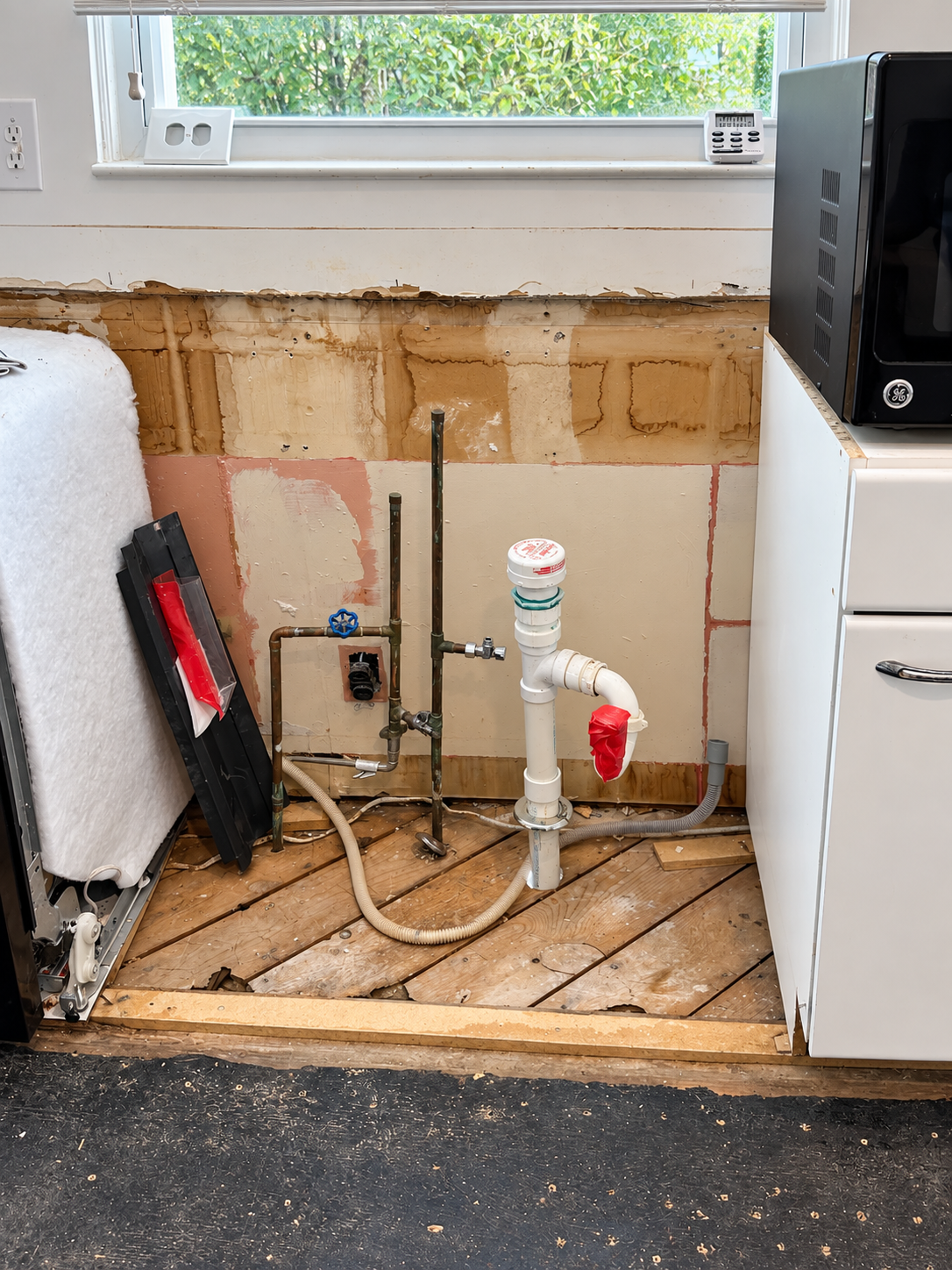 Exposed plumbing under the window