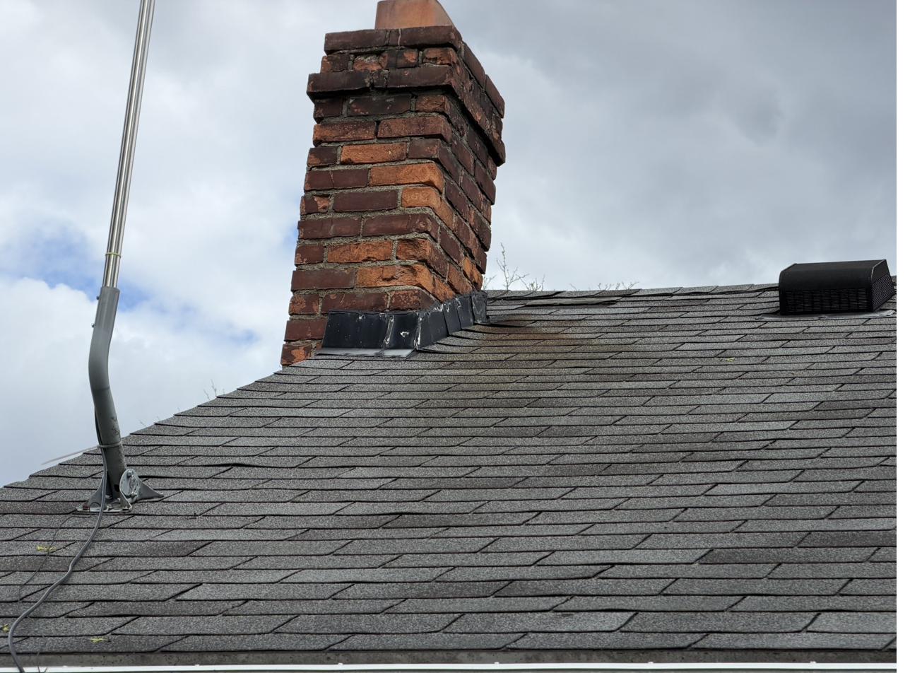 Brick chimney with step flashing reset