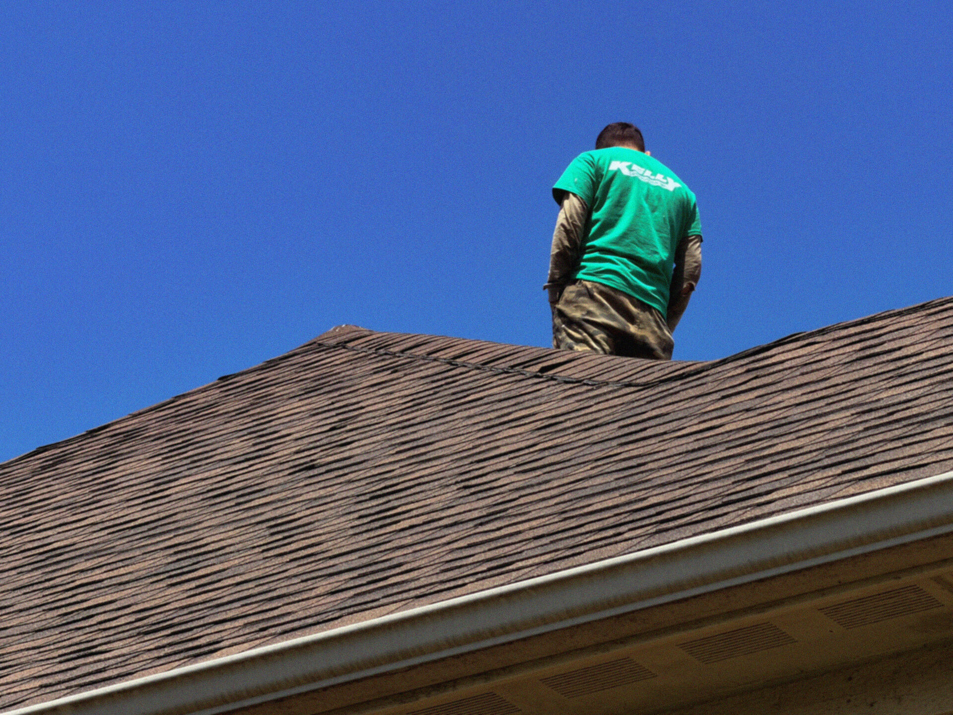 Kelly Construction crew member on a residential roof