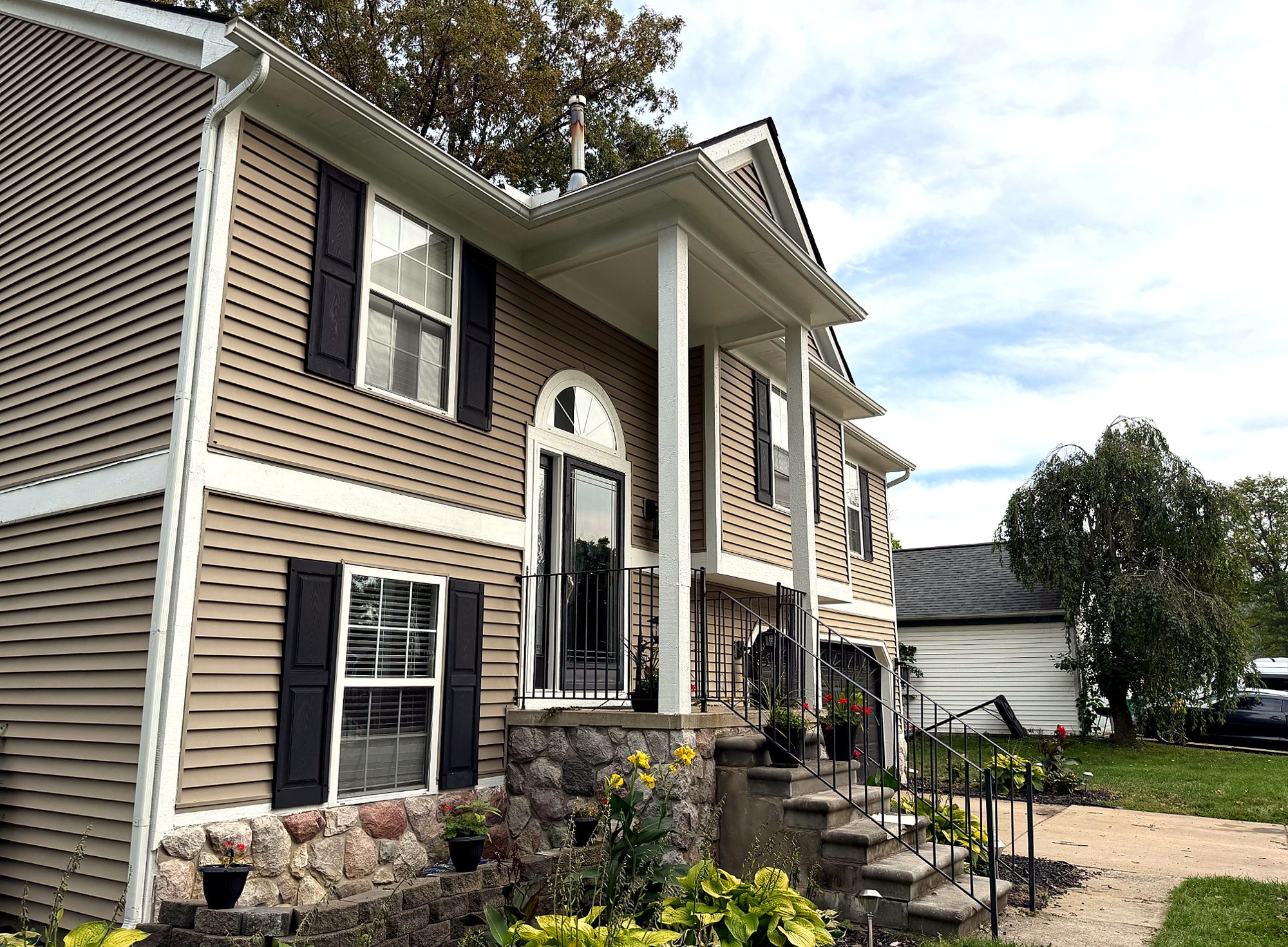 Finished front elevation, new siding and stone-veneer skirt